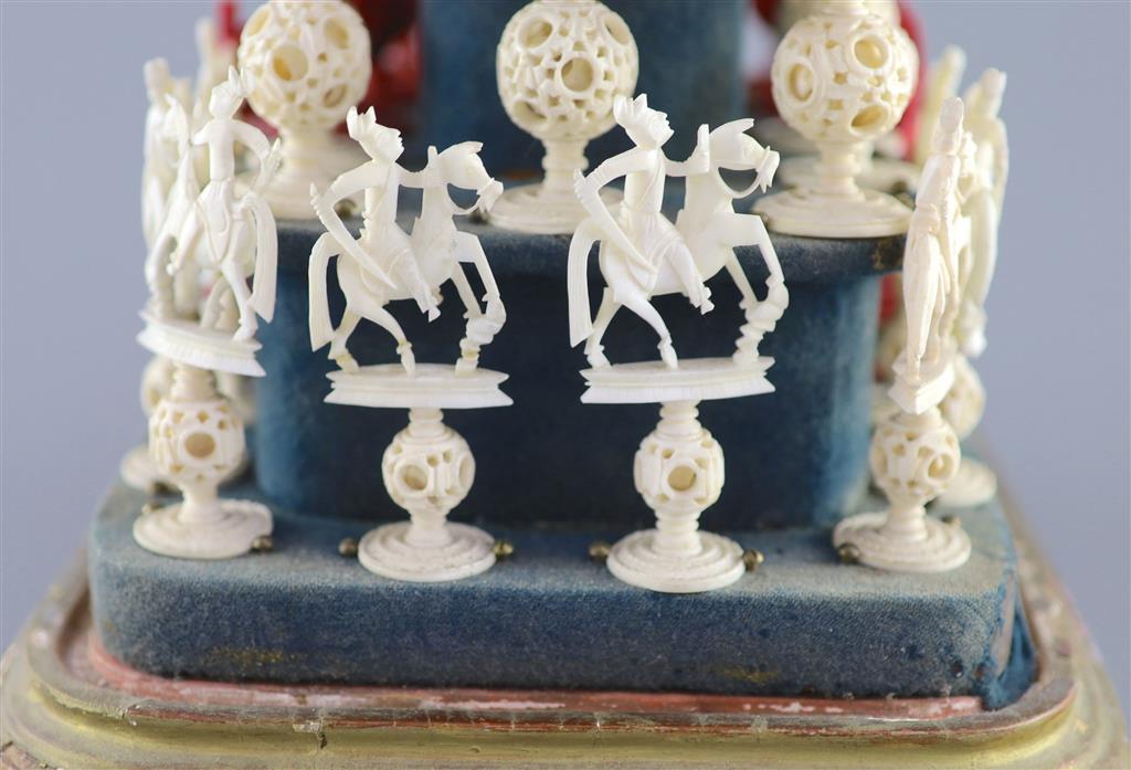 A set of 19th century Cantonese carved and red stained ivory chess pieces under dome, white king 20cm high
